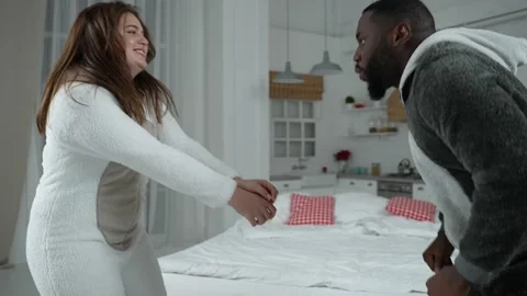 Joyful multi-ethnic couple high five during dance Stock-Footage 148686864