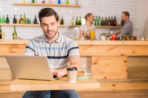 Joyful nice man sitting at the table Stock Photos