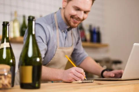 Joyful nice man using pencil Stock Photos