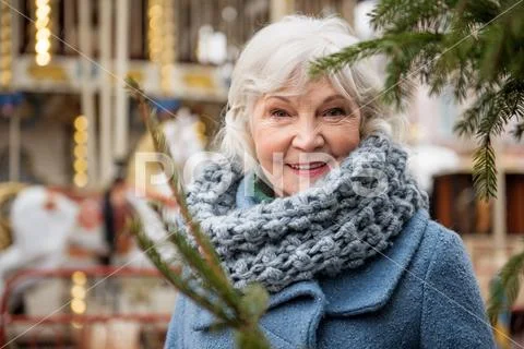 Joyful old lady breathing fresh air outdoor in winter Stock Photos