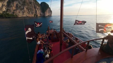 Joyful Pirate Ship Party by Phi Phi Island at Sunset with Flags and Adventure 動画素材 327454668