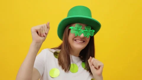 Joyful positive cheerful St. Patrick's Day leprechaun model female in green hat Stock Footage 293240934