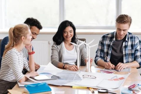 Joyful positive team of engineers working together Stock Photos