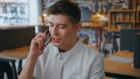 Joyful programmer cellphone call speaking at office closeup. Happy man talking Stock-Footage 280123353