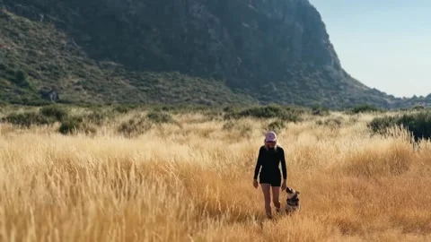 Joyful Run Through Sunrise Fields with Dog. Stock Footage 327755822