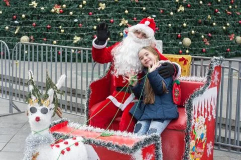 Joyful Santa Claus sitting with a girl Stock Photos