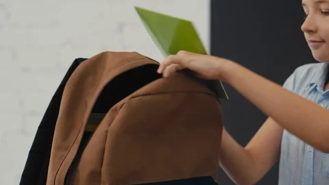 Joyful schoolboy prepares backpack for school. Back to School. Stock-Footage 92498855