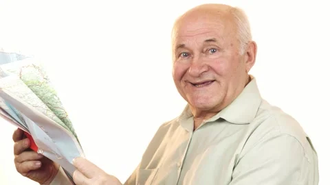 Joyful senior man exploring a map with a bright smile Stock Footage 311939792