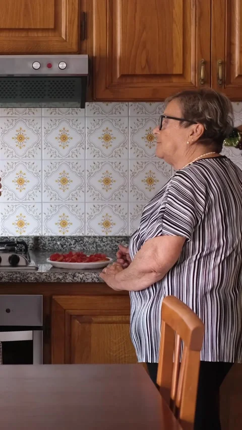 Joyful senior mother dancing with her adult daughter in a cozy home kitchen Stock Footage 344397018