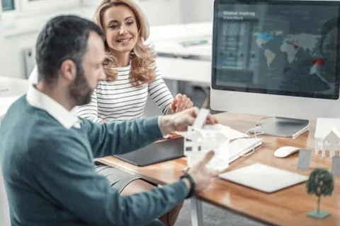 Joyful smart colleagues working in team together Stock Photos