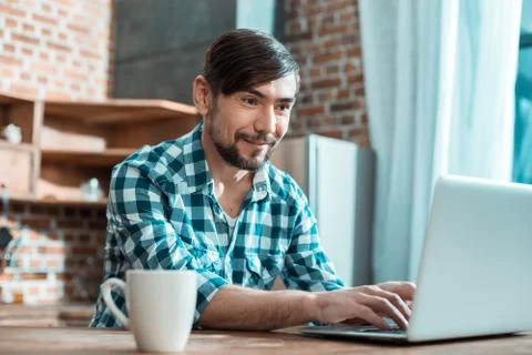 Joyful smart man working remotely Stock Photos