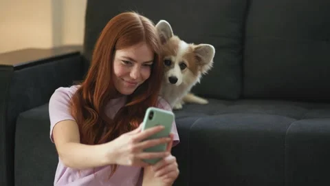 Joyful smiling attractive Red haired woman hugging Little funny corgi fluffy Stock Footage 150100144
