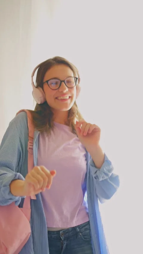Joyful student dancing during study break on white background. Great for campus Stock Footage 312640372