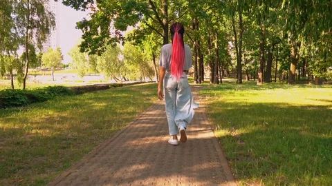 Joyful student walking outdoors Stock Footage 129920910