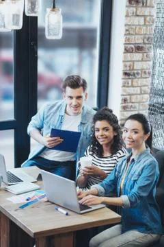 Joyful three colleagues developing business strategy Foto stock