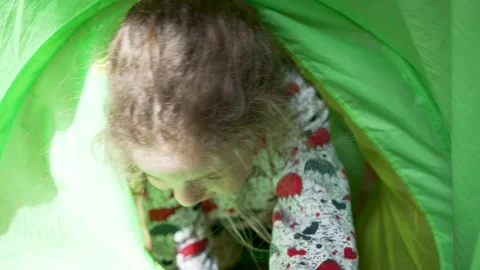 Joyful Toddler Playing Inside a Green Tunnel Stock Footage 306732209