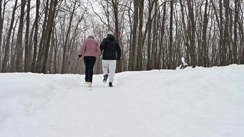 Joyful winter run through snowy forest trails Stock Footage 338415066