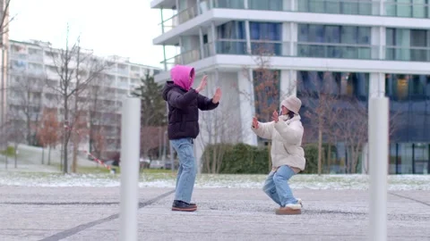A joyful winter video shows couples and friends dancing in the snow Stock Footage 316499686