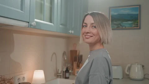 Joyful woman authentic breakfast routine. Cheerful woman serenely pouring coffee Stock Footage 342063941