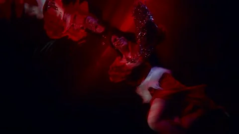 Joyful woman is floating in dramatic red depth of sea or pool, pretty lady is Stock-Footage 194521739