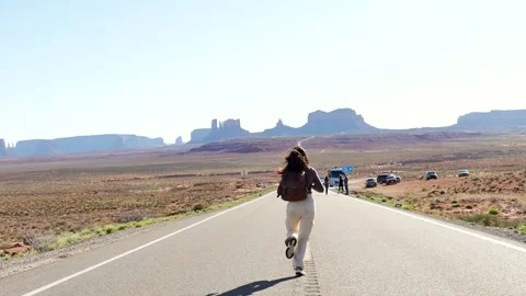 Joyful woman running down famous forrest gump point road Stock Footage 334852853