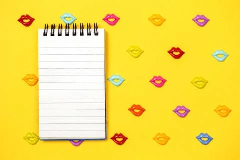 Joyful yellow pattern of lips with notepad Stock Photos
