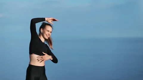 Joyful young female making exercise practicing outdoor workout. Medium shot on Video stock 135753538