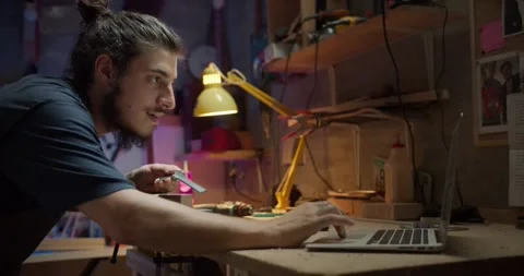 Joyful young Hispanic joiner connected to social media online using laptop on Stock Footage 137242854