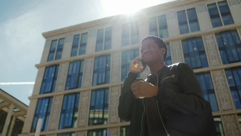 Joyful young man chatting on cell phone Stock Footage 90953296
