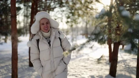 Joyful young man is strolling alone in park and playing with pine branches in Stock Footage 171182523