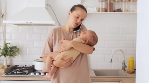Joyful young mom talking on mobile Stock Video Pond5