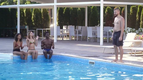 Joyful young people having fun in swimming pool Video stock 114979232