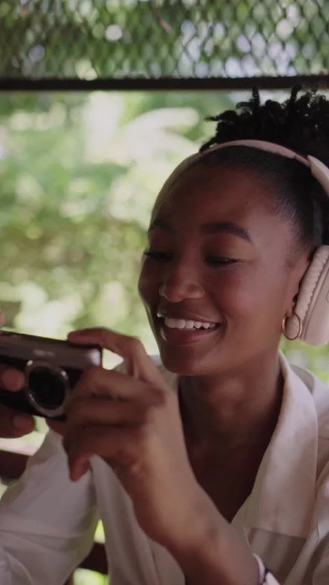 Joyful young photographer laughing while taking pictures Stock Footage 345683734