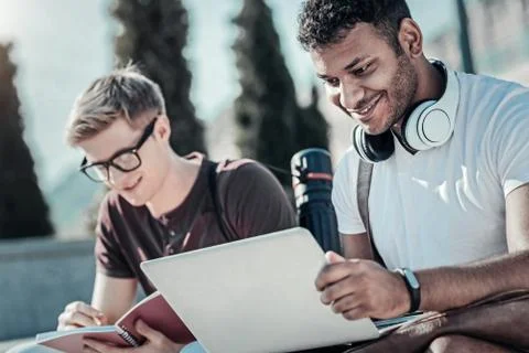 Joyful young student using a laptop Stock Photos