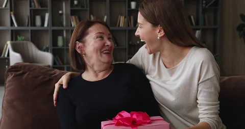 Joyful young woman congratulating elderly mother with birthday. Stock Footage