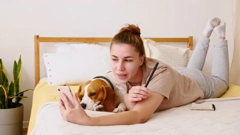 A joyful young woman taking selfie with pet using phone. Mans best Friend. Slow Stock Footage 163206853