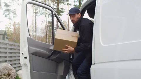 Joyfull Delivery Man Comes Out of His Cargo Van and Goes Towards Camera. Stock Footage 69722253