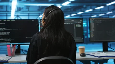 Joyous admins at PC desk in high tech facility overseeing server clusters Stock Footage 276140121