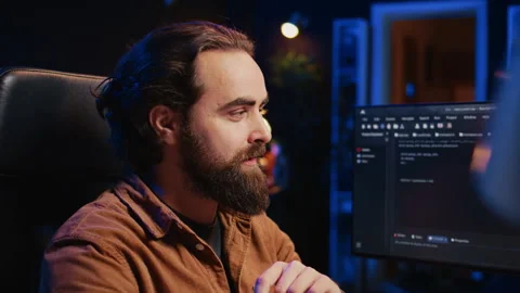 Joyous IT admin looking at PC screen, pleased after solving script errors Stock Footage 265617399