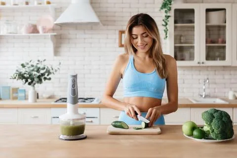 Joyous lady making a vegetable-based meal Stock Photos