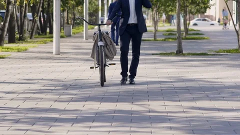 Joyous manager with bicycle talking by mobile phone Stockbeeldmateriaal 120665857
