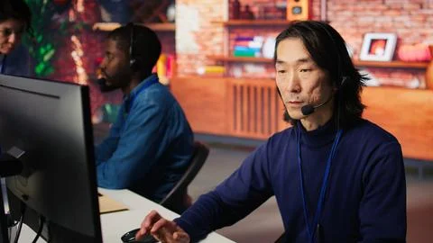 Joyous technical support senior agent working in call center office Stock Photos
