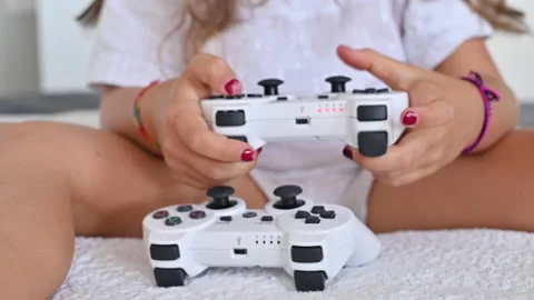 Joystick for a computer game in the hands of a child, close-up. A little girl pl Stock Footage 138228865