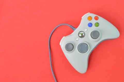 Joystick game controller isolated on a red background. Stock Photos