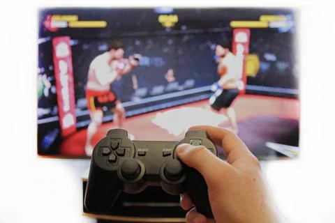 Joystick for video game consoles in the hands Stock Photos