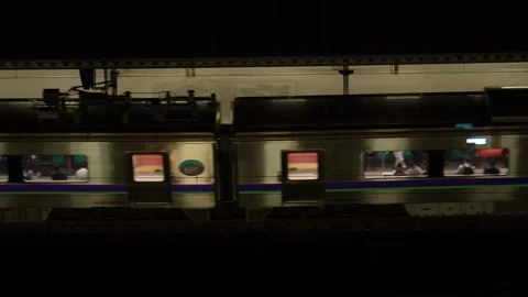 JR train leaving station platform at night, Hakodate, Japan, 2026.09.10. Stock Footage 345427797