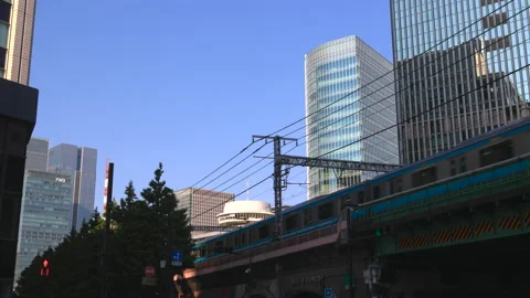 JR train runs on the elevated railway track in Yurakucho Tokyo Japan Video stock 209164984