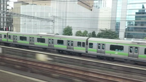 JR Yamanote Line in Tokyo JR train viewed from another moving train Stock Footage