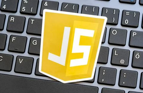 JS, JavaScript programming language logo laying on a modern computer keyboard Stock Photos
