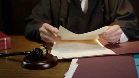Judge closes up folder and hammers his gavel to end court case Stock Footage 72963715